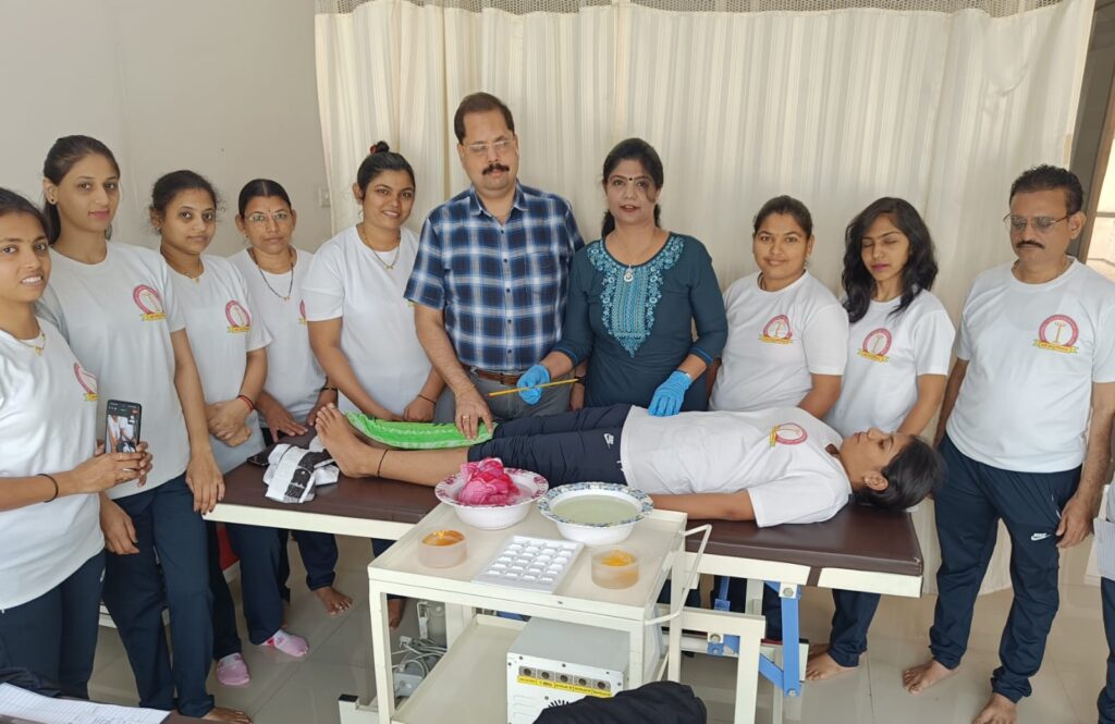 Student practicing naturopathy in a hands‑on session at Ashirwad Yog‑Naturopathy College, Nashik, guided by founders Dr. Nitin Shimpi and Mrs. Minal Shimpi.