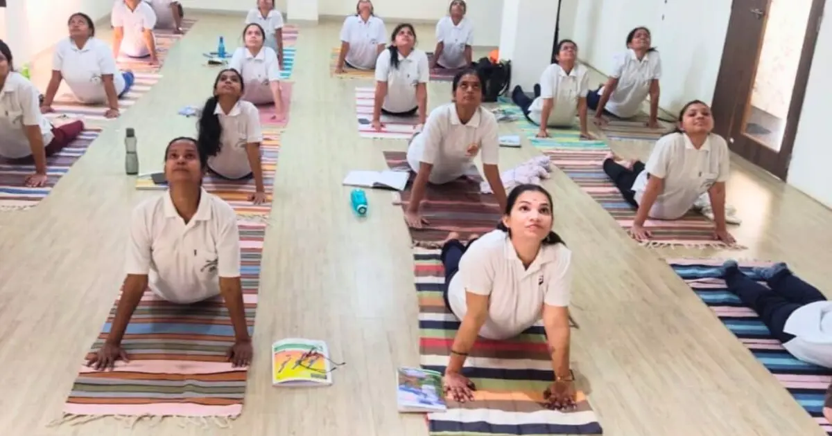 Yoga and naturopathy students attending practical yoga session